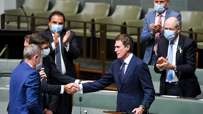 Liberal member for Pearce Christian Porter is congratulated by Angus Taylor after delivering his valedictory speech in the House of Representatives.