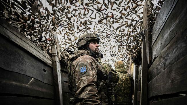 Ukrainian troops patrol at the frontline outside the town of Novoluhanske, in eastern Ukraine. Picture: AFP