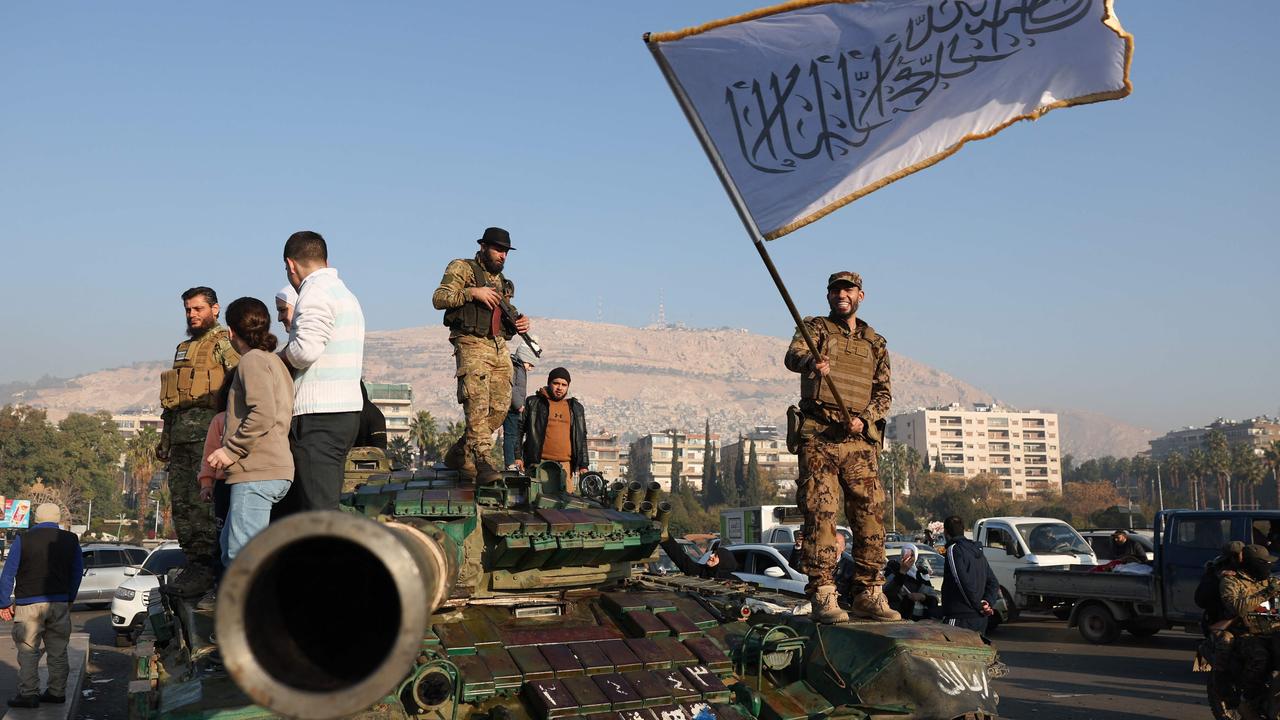 Rebel fighters standing on top of a tank in Damascus. Picture: Omar Haj Kadour/AFP