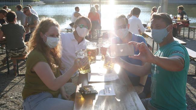 Guests enjoy the sun at the Seehaus beer garden in the English Garden park in Munich, Germany. Picture: Getty Images