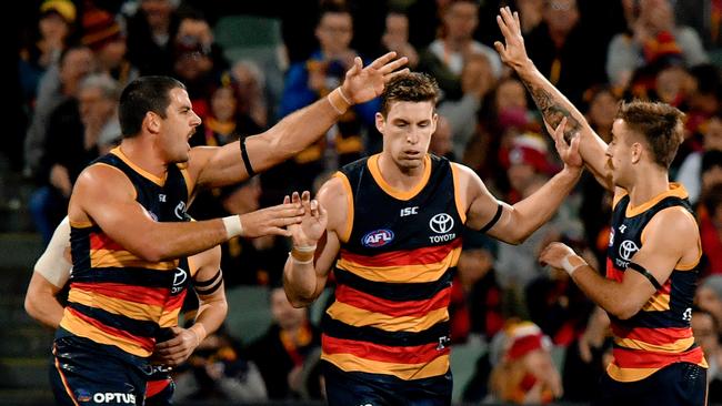 Taylor Walker, Josh Jenkins and Jordan Gallucci celebrate a goal in the important home win against the Giants. Picture: AAP Image/Sam Wundke