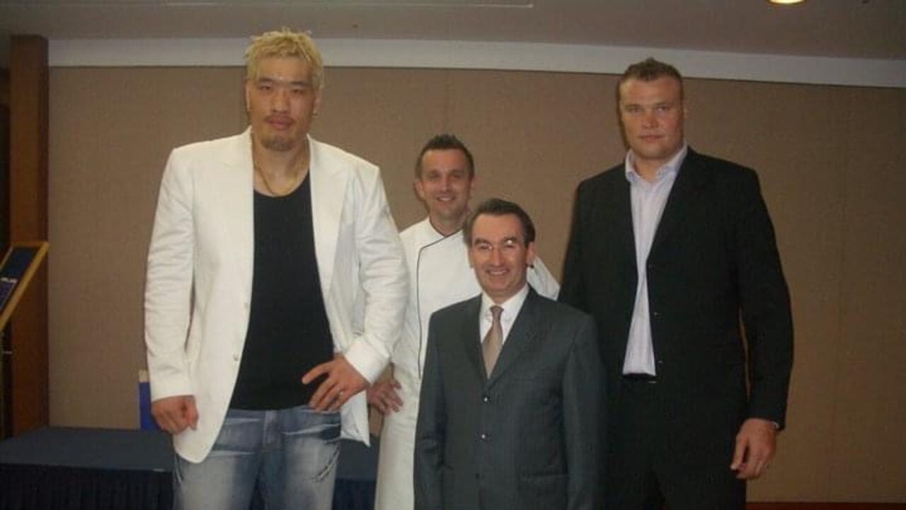 Paul Schenk (middle back), who stands tall at 6 foot 3 inches, with world heavy weight kick boxers at his hotel in Seoul. Photo: Supplied