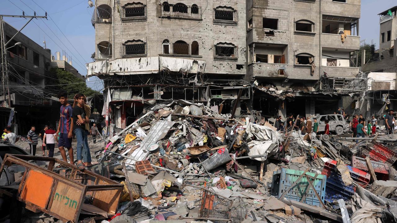 People gather amid the destruction following Israeli strikes on Al-Shatee camp in Gaza City on October 28. Picture: Mohammed Abed / AFP