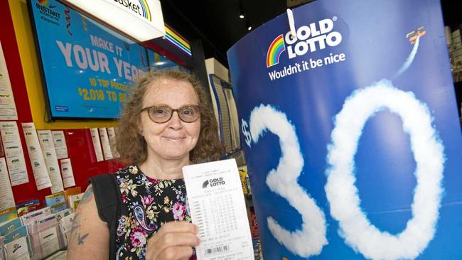 Corrie Johnston buys a ticket in the $30 million Gold Lotto from Newsextra Central City, Thursday, December 28, 2017. Picture: Kevin Farmer