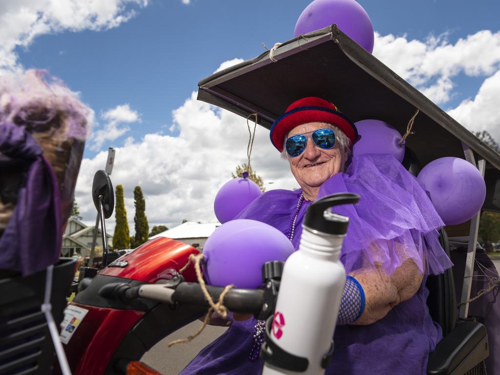 Getting in touch with her purple side on Jacaranda Day is Diana Collins who has lived in Goombungee for the past 35 years, Saturday, November 5, 2022. Picture: Kevin Farmer