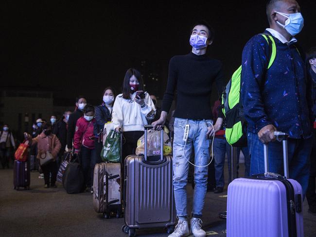 Passengers line up to enter Wuchang railway station in Wuhan, Hubei Province, China, after the Chinese government lifted travel restrictions. Picture: Getty Images