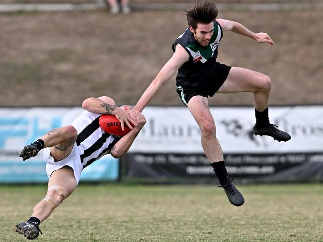 Eastern: Scoresby’s Todd Morgan cops it from Donvale’s Luke Manion. Picture: Andy Brownbill