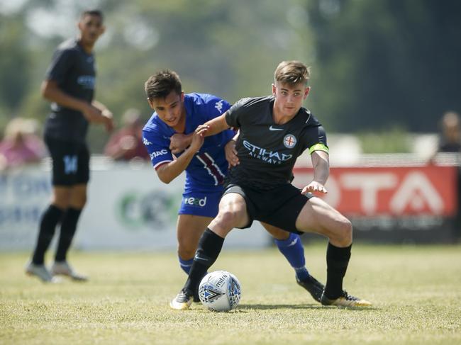 Jordan Templin (Langwarrin) and Connor Metcalfe (Melbourne) battle for the ball. Picture: Valeriu Campan