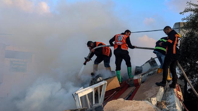 Members of the Palestinian civil defence extinguish a fire in a building following Israeli bombardments east of Rafah in the southern Gaza Strip on February 19, 2024, amid continuing battles between Israel and the Palestinian militant group Hamas. (Photo by SAID KHATIB / AFP)