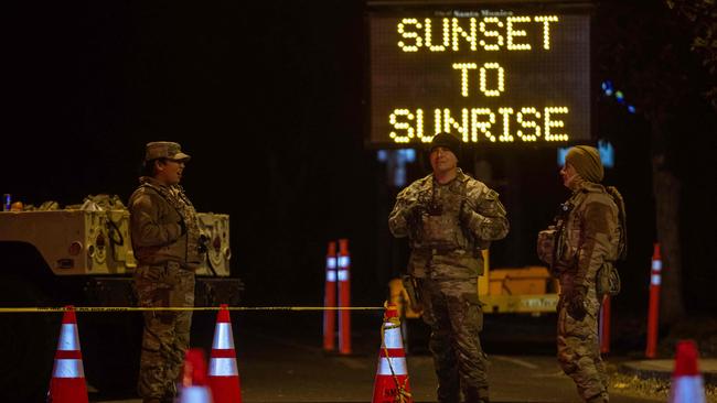 National Guard officers enforcing a curfew in evacuation order zones from 6:00 PM to 6:00 AM as wildfires cause damage and loss through LA region. Picture: Getty Images via AFP