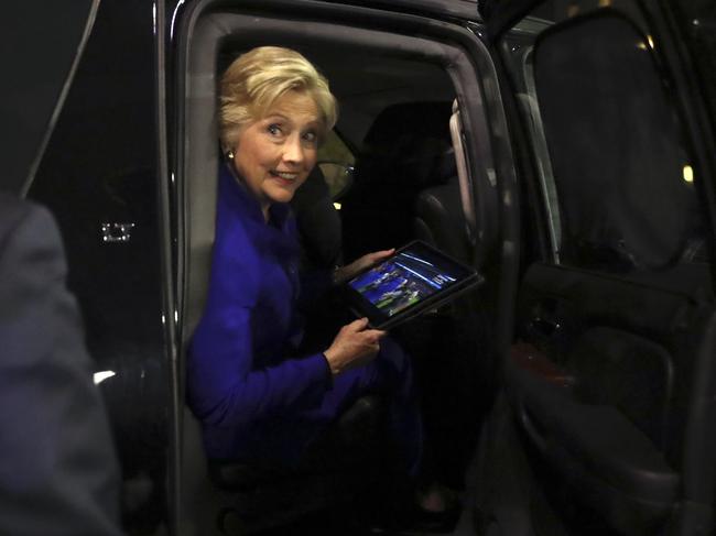 Democratic presidential candidate Hillary Clinton looks out of her vehicle as the Chicago Cubs win the World Series baseball Game 7 against the Cleveland Indians after her final campaign rally of the day at Arizona State University in Tempe, Ariz., Wednesday, Nov. 2, 2016. (AP Photo/Andrew Harnik)