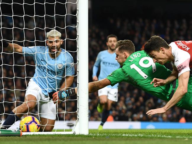 MANCHESTER, ENGLAND - FEBRUARY 03: Manchester City striker Sergio Aguero (l) looks on after scoring his hat trick goal despite the efforts of Arsenal goalkeeper Bernd Leno and Laurent Koscielny during the Premier League match between Manchester City and Arsenal FC at Etihad Stadium on February 03, 2019 in Manchester, United Kingdom. (Photo by Stu Forster/Getty Images) *** BESTPIX ***