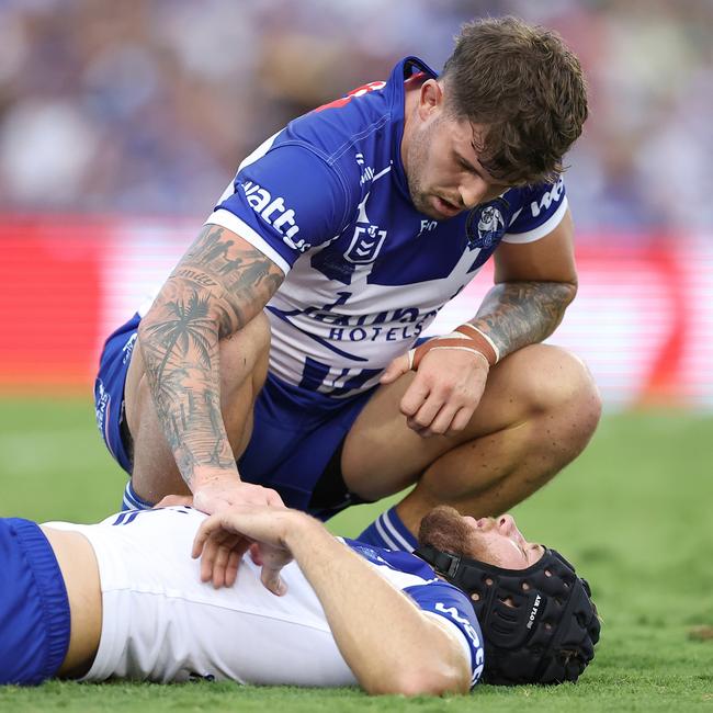 Toby Sexton of the Bulldogs looks after Matt Burton after Burton sustained an injury. Picture: Jeremy Ng/Getty Images