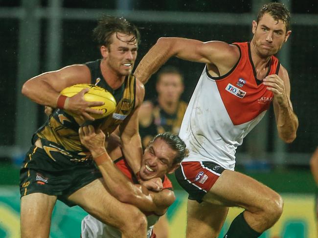 The NT Buffaloes’ Cameron Illett brings down Glenelg’s Luke Partington during their rep match at TIO Stadium on Saturday. Picture: Glenn Campbell