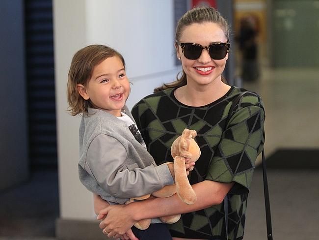 Laughing all the way home: Miranda Kerr and son Flynn at arrive in Sydney from Los Angeles. Picture: Ross Schultz