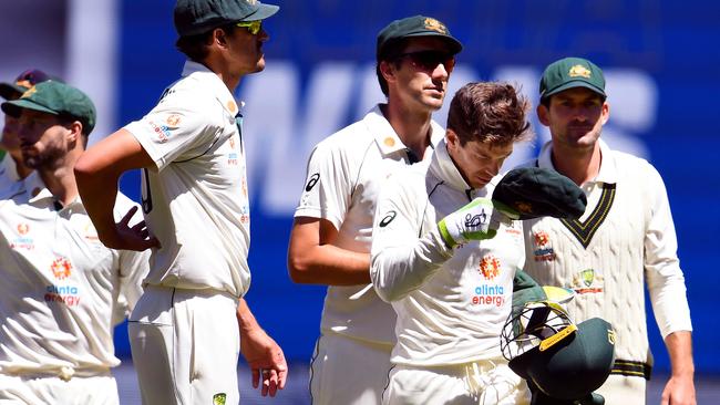 A demoralised Australian outfit, led by captain Tim Paine, leaves the field after its loss to India in the second Test. Picture: AFP