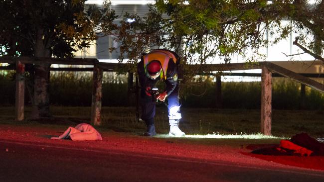 A police officer photographs the scene where the family was struck. Picture: Dean Asher