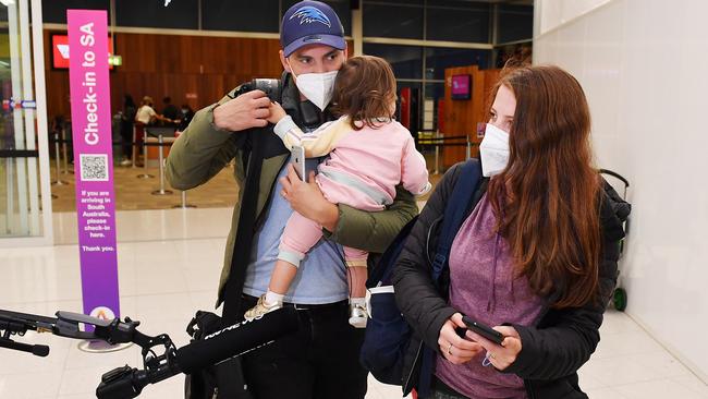 Rhys and Sofia Roscoe arrive at Adelaide Airport with their 20-month-old daughter Mia. Picture: Mark Brake