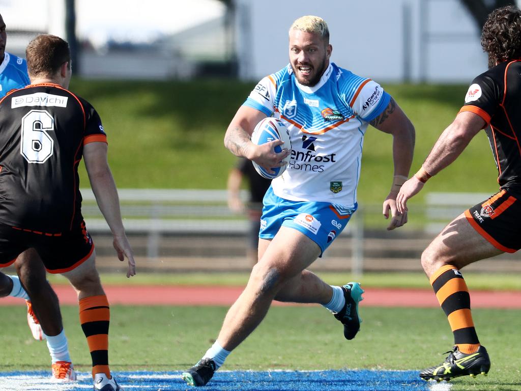 Pride's Paea Pua runs straight at the Tigers' defence. Picture: Brendan Radke