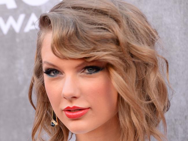 FILE - In this Sunday, April 6, 2014, file photo, Taylor Swift arrives at the 49th annual Academy of Country Music Awards at the MGM Grand Garden Arena in Las Vegas. Police in Rhode Island say they arrested three people outside Swift’s beachfront home after they accosted security guards at the singer’s property. Authorities say the three Connecticut residents were charged with misdemeanor breach of peace after they threw beer bottles and shouted expletives at the guards Sunday, June 15, 2014, outside Swift’s house in the Watch Hill section of Westerly. Swift wasn’t at the home at the time. (Photo by Al Powers/Powers Imagery/Invision/AP, File)