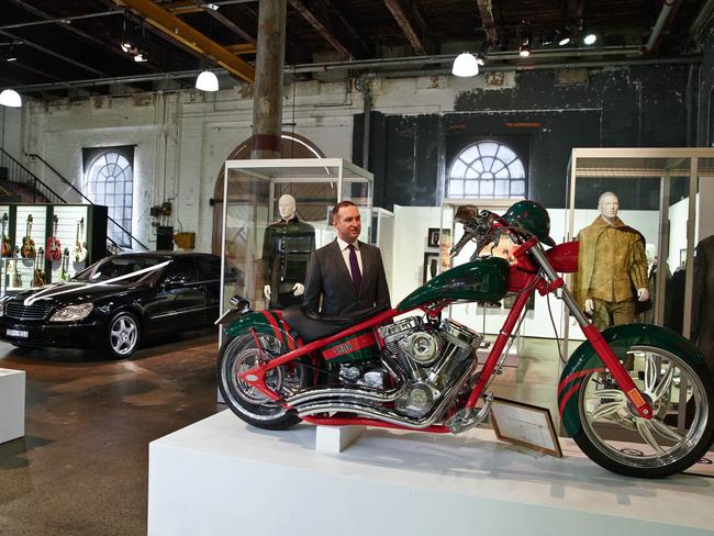 John Keats from Sotheby's Australia stands with items owned by actor Russell Crowe. Picture: AAP