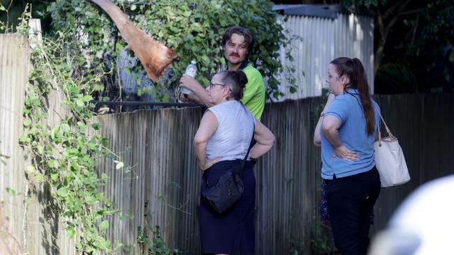 Residents survey the damage after the microburst storm hit suburbs in Brisbane’s east. Picture: Steve Pohlner