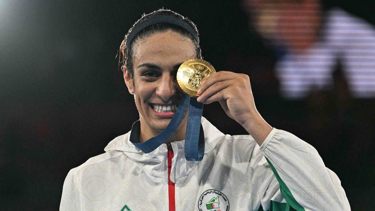 Imane Khelif poses on the podium during the medal ceremony for the women's 66kg final boxing category. (Photo by MOHD RASFAN / AFP)