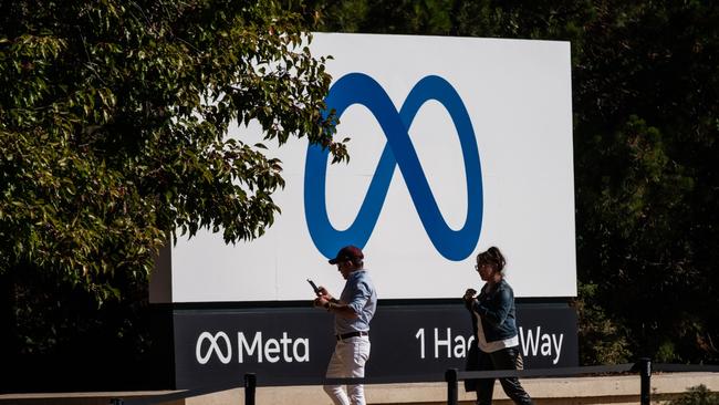 The company’s first annual drop in quarterly revenue, reported this summer, sparked several accusations that the metaverse really amounted to a costly distraction just as the advertising market was slowing. Above, visitors take photographs in front of signage at Meta Platforms headquarters in Menlo Park, California. Picture: Bloomberg