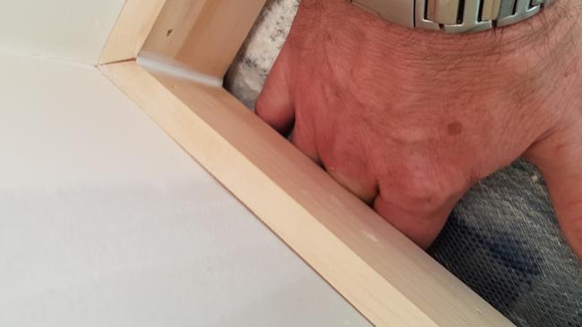 Rod Mattingley can fit his hand under an internal wall of his new home. Photo: Supplied