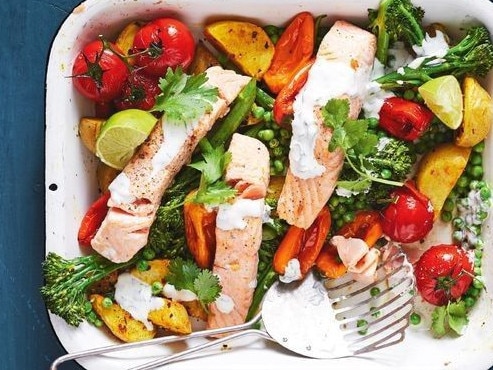 Belly fat recipes: Healthy salmon, potato and broccoli tray bake.