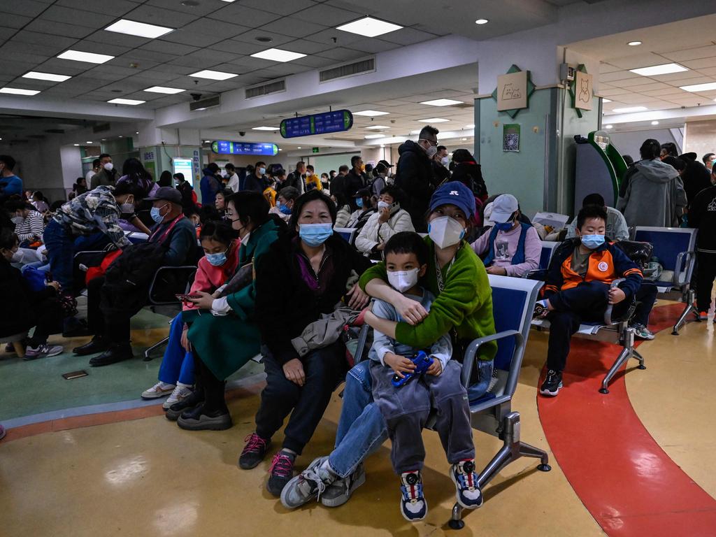 Children and their parents wait at an outpatient area at a children hospital in Beijing on November 23. (Photo by Jade Gao / AFP)