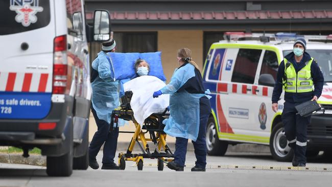 Ambulance officers remove a resident from the St Basil's aged care home