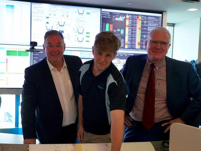 Queensland Resources Minister Scott Stewart,  Santos production engineer Paul Weller and Santos Executive vice president Onshore Oil and Gas Rob Simpson look over a map of the new area the company will prospect in.