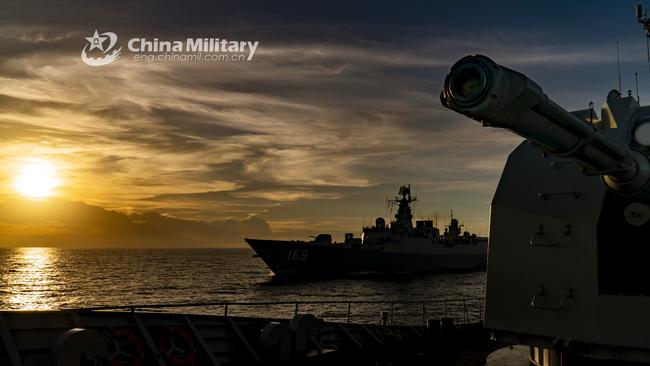 The guided-missile frigate Hengyang (Hull 568) and the guided-missile destroyer Wuhan (Hull 169) attached to a destroyer flotilla with the navy under the PLA Southern Theater Command steam alongside with each other during a maritime manoeuvre operation in waters of the South China Sea.