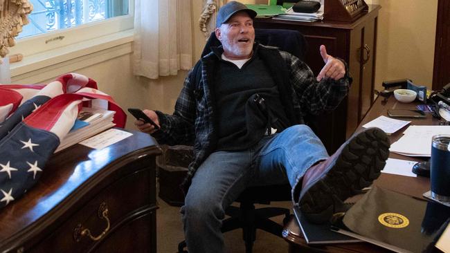 A supporter of US President Donald Trump sits inside the office of US Speaker Nancy Pelosi. Picture: Saul Loeb/AFP