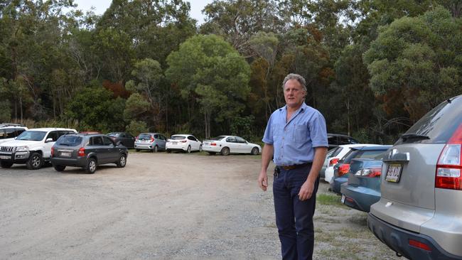 Tim Gregg at the Ormeau Train Station overflow carpark which is close to bushland, poorly lit and poses a safety risk to commuters, especially women after dark. they will receive 70 extra spaces by next year.