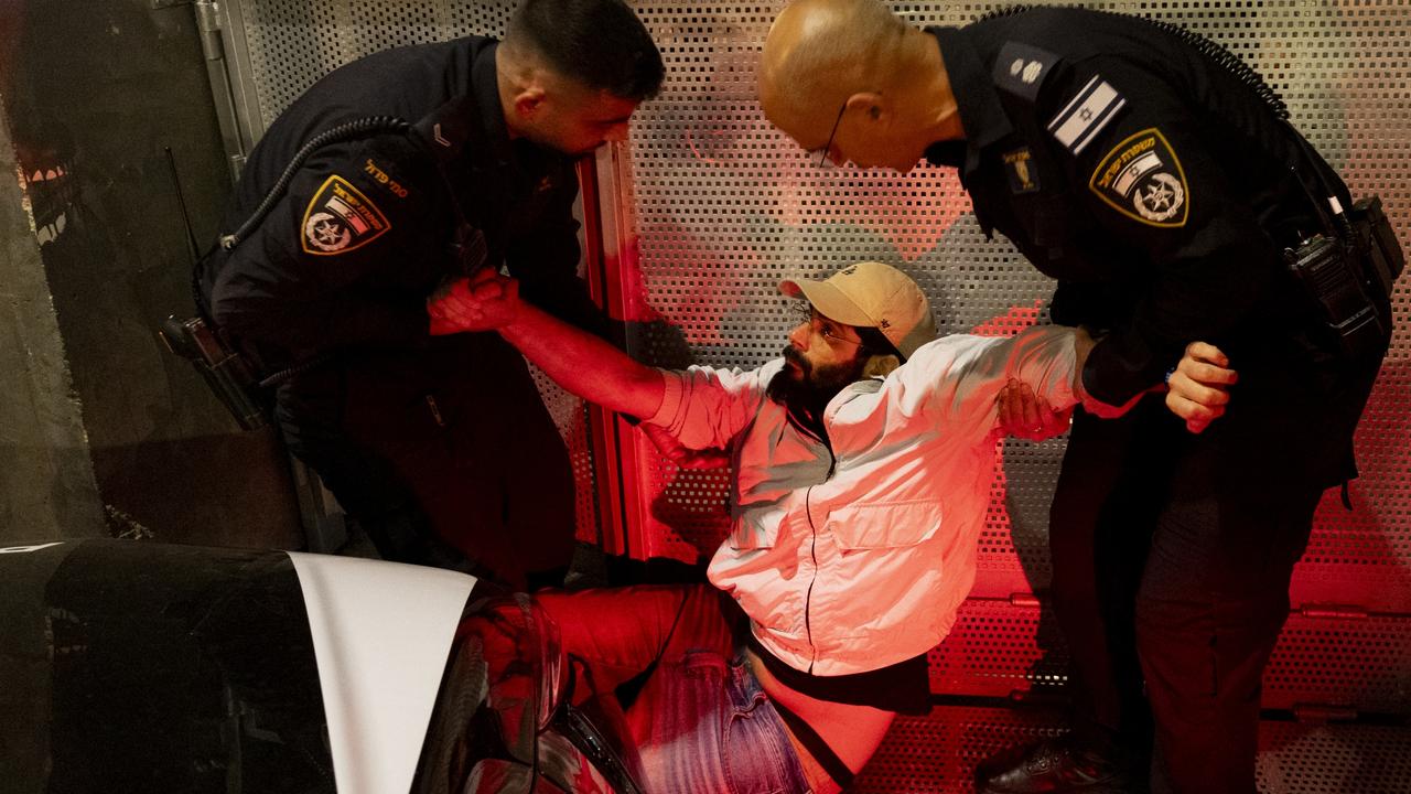 Police officers detain a protester during a demonstration. Picture: Getty