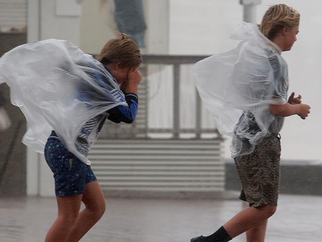 Battling the wind and rain in Manly / Picture: Adam Ward