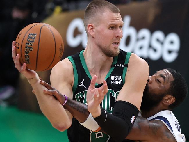 BOSTON, MASSACHUSETTS - JUNE 09: Kristaps Porzingis #8 of the Boston Celtics is defended by Kyrie Irving #11 of the Dallas Mavericks during the fourth quarter in Game Two of the 2024 NBA Finals at TD Garden on June 09, 2024 in Boston, Massachusetts. NOTE TO USER: User expressly acknowledges and agrees that, by downloading and or using this photograph, User is consenting to the terms and conditions of the Getty Images License Agreement.   Adam Glanzman/Getty Images/AFP (Photo by Adam Glanzman / GETTY IMAGES NORTH AMERICA / Getty Images via AFP)