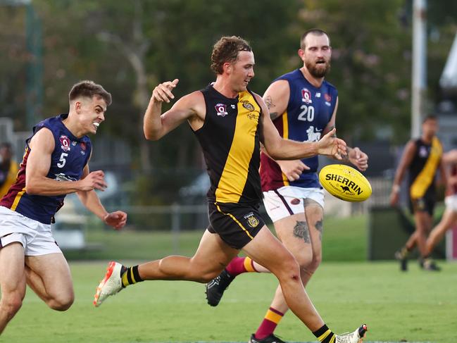 Tigers' James Bennett kicks down the field in the AFL Cairns premiership men's preliminary final match between the Cairns City Lions and the North Cairns Tigers, held at Cazalys Stadium, Westcourt. Picture: Brendan Radke