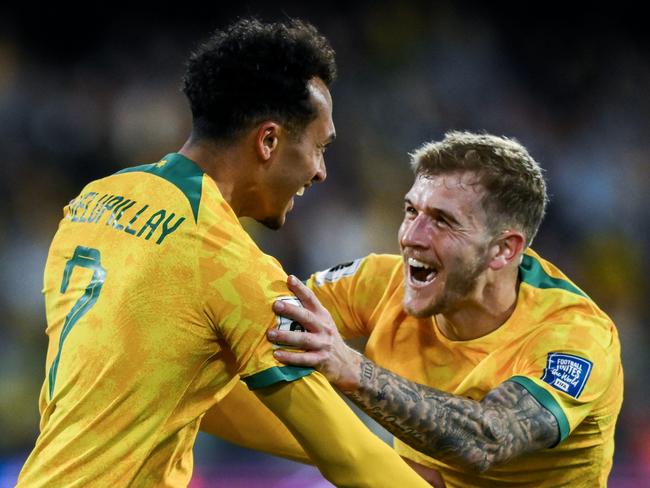 ADELAIDE, AUSTRALIA - OCTOBER 10: Nishan Velupillay of the Socceroos  celebrates after scoring his teams third  goal with  Riley McGree of the Socceroos   during the third round FIFA World Cup 2026 Qualifier match between Australia Socceroos and China PR at Adelaide Oval on October 10, 2024 in Adelaide, Australia. (Photo by Mark Brake/Getty Images)