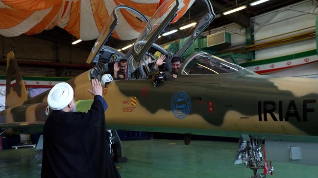 President Rouhani waves to pilots in the new jet. Picture: AFP