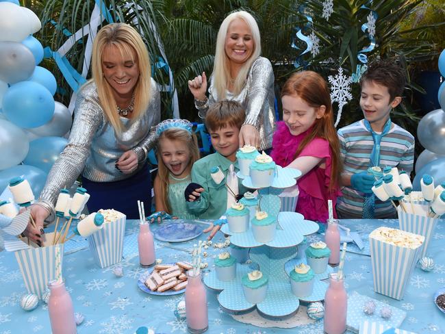 Sisters Alison Cook and Cassandra Marshall with party supplies with the same theme as Frozen; a movie that their kids love. Charlotte Marshall, 5, and Nathan Marshall, 7 with cousins Anneliese Cook, 10 and Matthew Cook, 8.