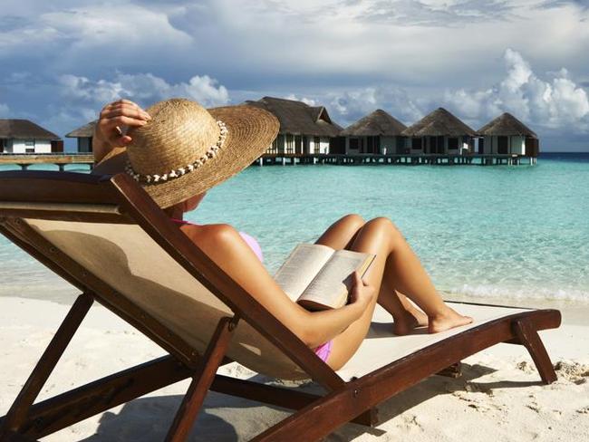 Young woman reading a book at beach