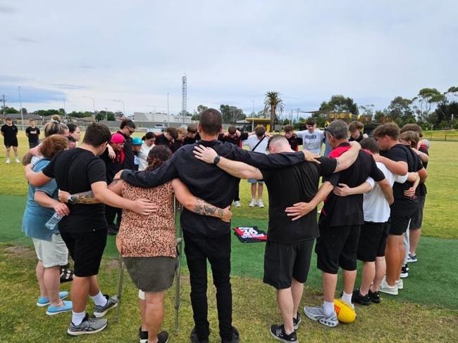 Loved ones from the Carrum Downs football club honour Kai McDonald, laying his guernsey in the middle of the oval. Picture: Supplied