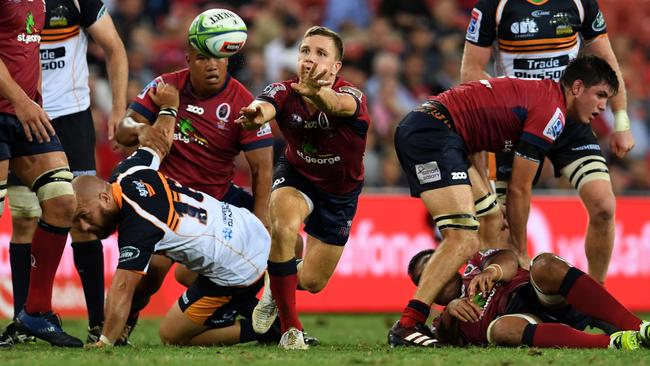 Reds halfback James Tuttle gets the ball away against the Brumbies at Suncorp Stadium last night. Picture: AAP