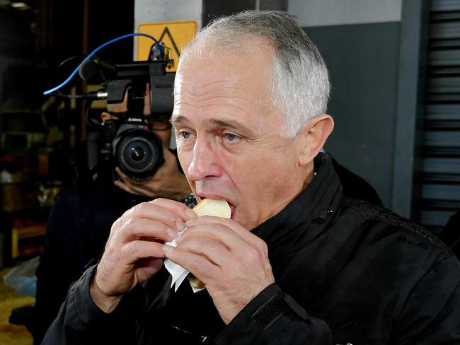 Prime Minister Malcolm Turnbull enjoys a ‘democracy sausage’. Picture: Jason Edwards