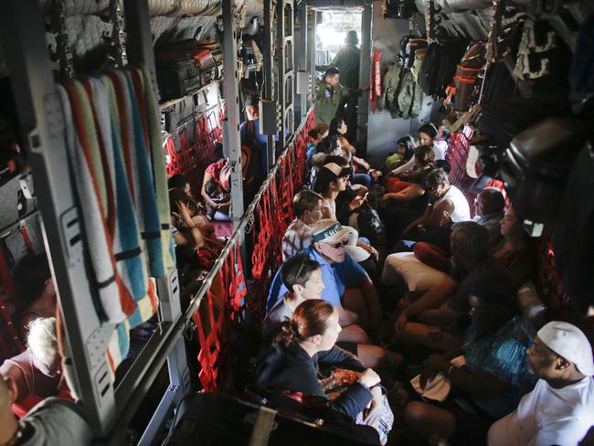 Tourists and locals are evacuated on a Mexican air force cargo plane.