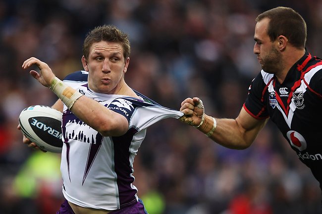 <p>Warriors v Storm: Ryan Hoffman tries to fend off Warriors captain Simon Mannering.</p>