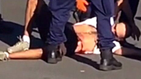 The man on the ground after being shot outside Campbelltown Railway Station.